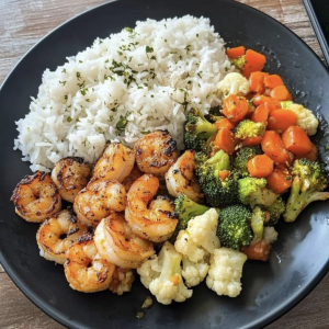 Shrimp Platter, Over Jasmine Rice, Mix Vegetables, Carrots, Broccoli, Cauliflower<br> <br><div style="display: flex; justify-content: center; align-items: center; gap: 10px; font-family: Arial, sans-serif;"><div style="text-align: center; color: #21924e;"> <p style="margin: 0; font-size: 15px; font-weight: bold;">40G</p> <p style="margin: 0; font-size: 10px; text-transform: uppercase;">Protein</p> </div> <div style="border-left: 2px solid #21924E; height: 40px;"></div> <div style="text-align: center; color: #21924e;"> <p style="margin: 0; font-size: 15px; font-weight: bold;">130G</p> <p style="margin: 0; font-size: 10px; text-transform: uppercase;">Carbs</p> </div><div style="border-left: 2px solid #21924E; height: 40px;"></div> <div style="text-align: center; color: #21924e;"> <p style="margin: 0; font-size: 15px; font-weight: bold;">110G</p> <p style="margin: 0; font-size: 10px; text-transform: uppercase;">Veg</p> </div> <div style="border-left: 2px solid #21924E; height: 40px;"></div><div style="text-align: center; color: #21924e;"> <p style="margin: 0; font-size: 15px; font-weight: bold;">18G</p> <p style="margin: 0; font-size: 10px; text-transform: uppercase;">fat</p> </div></div>